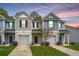 Charming townhouse featuring gray siding, a single-car garage, and well-manicured landscaping at 164 Buchanan Cir, Goose Creek, SC 29445