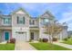 Well-kept townhome with gray siding, garage, black shutters, and landscaping in a verdant setting at 164 Buchanan Cir, Goose Creek, SC 29445