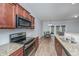 Modern kitchen featuring granite countertops, stainless steel appliances, and a view of the living room at 164 Buchanan Cir, Goose Creek, SC 29445