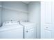 A laundry room with a white washer and dryer and a wire shelf for storage at 164 Buchanan Cir, Goose Creek, SC 29445