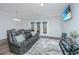 Comfortable living room featuring hardwood floors, a comfortable sofa, and access to the backyard at 164 Buchanan Cir, Goose Creek, SC 29445
