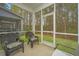 Comfortable screened-in patio with chairs and a view of the green lawn and trees at 164 Buchanan Cir, Goose Creek, SC 29445