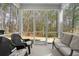 Inviting screened porch with comfortable seating, offering views of the wooded backyard at 164 Buchanan Cir, Goose Creek, SC 29445