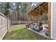 Backyard showcasing a covered patio with a swing and outdoor furniture, ideal for relaxation at 176 Daniels Creek Cir, Goose Creek, SC 29445