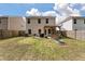 Spacious backyard with a wooden pergola, fire pit, and a well-maintained lawn at 176 Daniels Creek Cir, Goose Creek, SC 29445