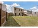 Expansive backyard with a wooden pergola, a well-kept lawn, and a privacy fence at 176 Daniels Creek Cir, Goose Creek, SC 29445