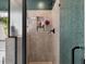 Updated bathroom shower area featuring tile walls, mosaic backsplash, and an open glass shower door at 176 Daniels Creek Cir, Goose Creek, SC 29445