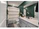 Charming bathroom with white vanity, mirror, toilet, shower with curtain, and bold accent wall at 176 Daniels Creek Cir, Goose Creek, SC 29445