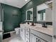 Bathroom with double sink vanity, modern fixtures, gray tile floor, and decorative mirrors at 176 Daniels Creek Cir, Goose Creek, SC 29445