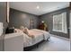 Cozy bedroom with neutral carpet, accent walls, a dresser, and a bright window view at 176 Daniels Creek Cir, Goose Creek, SC 29445