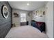 Bedroom with dark accent wall and decoratively framed wall hangings with carpeted floors at 176 Daniels Creek Cir, Goose Creek, SC 29445