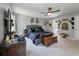 Primary bedroom with gray walls, carpet flooring, ceiling fan, gray upholstered bed and decorative wall decor at 176 Daniels Creek Cir, Goose Creek, SC 29445
