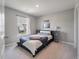 Bright bedroom features neutral carpet, gray walls, and a large window with neighborhood views at 176 Daniels Creek Cir, Goose Creek, SC 29445