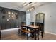 Modern dining room featuring a wooden table, a bench, and decorative wall art at 176 Daniels Creek Cir, Goose Creek, SC 29445