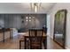 Inviting dining room features dark wood floors, dining table with black chairs, and stylish decor against a black accent wall at 176 Daniels Creek Cir, Goose Creek, SC 29445