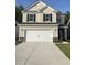 Charming two-story home featuring a two-car garage, stone accents, and a well-manicured lawn at 176 Daniels Creek Cir, Goose Creek, SC 29445