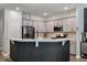 Bright kitchen featuring gray cabinets, stainless appliances, and a breakfast bar at 176 Daniels Creek Cir, Goose Creek, SC 29445