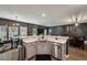 Bright kitchen featuring white countertops, gray cabinets, stainless steel appliances, an open dining area and dark accent wall at 176 Daniels Creek Cir, Goose Creek, SC 29445