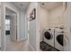Bright laundry room featuring a modern washer and dryer, plus convenient shelf space at 176 Daniels Creek Cir, Goose Creek, SC 29445