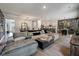 Open-concept living area with a large sectional sofa, dining space, and a modern kitchen at 176 Daniels Creek Cir, Goose Creek, SC 29445
