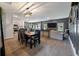 An open-concept kitchen, dining and living room area featuring hardwood floors and a large gray couch at 176 Daniels Creek Cir, Goose Creek, SC 29445
