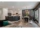Open-concept living and kitchen area featuring a breakfast nook, stylish decor, hardwood floors and a cozy gray couch at 176 Daniels Creek Cir, Goose Creek, SC 29445