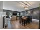An open-concept dining and living room area featuring a large dark accent wall and hardwood floors at 176 Daniels Creek Cir, Goose Creek, SC 29445