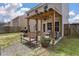 Cozy backyard patio featuring a wooden pergola with a swing and comfortable seating at 176 Daniels Creek Cir, Goose Creek, SC 29445