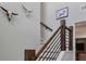 Interior shot of a stylish staircase with a unique wooden railing and decorative wall accents at 176 Daniels Creek Cir, Goose Creek, SC 29445