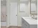 Bathroom featuring tiled floors, vanity with gray cabinetry, and tiled shower with sliding glass door at 1806 Long Bend Dr, Seabrook Island, SC 29455