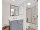 Bathroom features a vanity with gray cabinetry, a framed mirror, and a tiled shower at 1806 Long Bend Dr, Seabrook Island, SC 29455