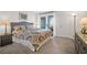 Bright bedroom with a king bed, neutral carpeting, and sliding glass doors to a balcony at 1806 Long Bend Dr, Seabrook Island, SC 29455