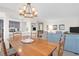 Open-concept dining room featuring a large wooden table and stylish chandelier next to a bright living area at 1806 Long Bend Dr, Seabrook Island, SC 29455