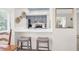 Modern kitchen features a breakfast bar with seating, stainless steel appliances, and gray cabinetry at 1806 Long Bend Dr, Seabrook Island, SC 29455