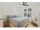 Bright bedroom with natural light, king bed, plantation shutters, and a comfortable armchair at 200 Bucksley Ln # 105, Charleston, SC 29492