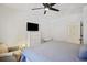 Cozy bedroom featuring a king bed, mounted TV, ceiling fan, and a comfortable seating area at 200 Bucksley Ln # 105, Charleston, SC 29492