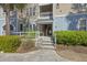 Inviting condominium entrance with stairway, fresh landscaping, and a well-maintained exterior at 200 Bucksley Ln # 105, Charleston, SC 29492