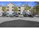 Attractive building exterior with parking, palm trees, inviting entry, and classic architectural details at 200 Bucksley Ln # 105, Charleston, SC 29492
