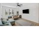 Bright living room featuring hardwood floors, a ceiling fan, and comfortable seating at 200 Bucksley Ln # 105, Charleston, SC 29492