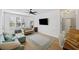 Open-concept living room featuring a large TV, natural light, a sofa, and a dining area at 200 Bucksley Ln # 105, Charleston, SC 29492