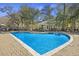 Sparkling pool area with lounge chairs, mature trees, and a relaxing outdoor retreat at 200 Bucksley Ln # 105, Charleston, SC 29492