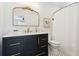 Bathroom featuring a black vanity with gold hardware, gold fixtures, and framed mirror at 2022 Chatelain Way, Mount Pleasant, SC 29464