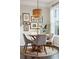 Charming dining area featuring a round wooden table, neutral chairs, and an artistic gallery wall at 2022 Chatelain Way, Mount Pleasant, SC 29464
