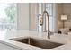 Close up of kitchen sink with quartz countertop and modern faucet at 2022 Chatelain Way, Mount Pleasant, SC 29464