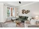 Comfortable living room featuring a sectional sofa, modern shelving, and natural light from the window at 2022 Chatelain Way, Mount Pleasant, SC 29464