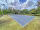 Well-maintained tennis court surrounded by lush trees, offering a perfect spot for sports and recreation at 2022 Chatelain Way, Mount Pleasant, SC 29464