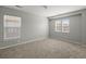 Neutral bedroom with carpeted floors and two windows allowing natural light at 206 Woodbrook Way, Moncks Corner, SC 29461