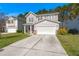 Inviting two-story home featuring a concrete driveway, attached two-car garage, and landscaped front yard at 206 Woodbrook Way, Moncks Corner, SC 29461