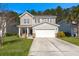 Charming two-story home with a well-manicured lawn and a spacious two-car garage at 206 Woodbrook Way, Moncks Corner, SC 29461