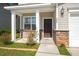 A welcoming front porch with brick accents and white columns, leading to the front door at 206 Woodbrook Way, Moncks Corner, SC 29461